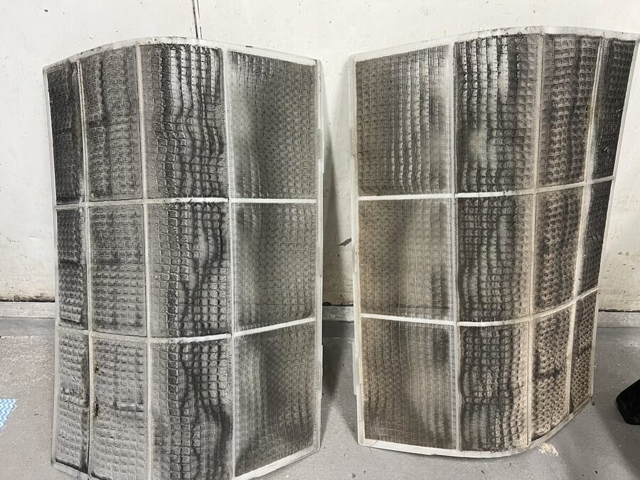 Aircon filters before a deep clean, thick with dust and mould