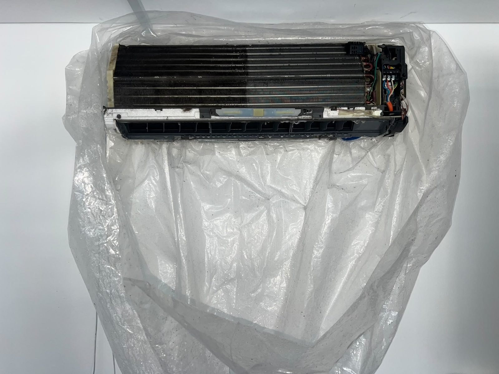 Split system taken apart on site under a protective sheet